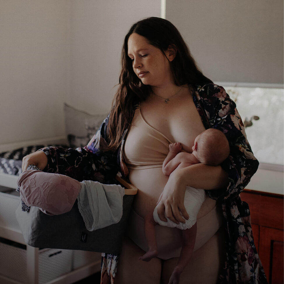 woman sitting breastfeeding her baby